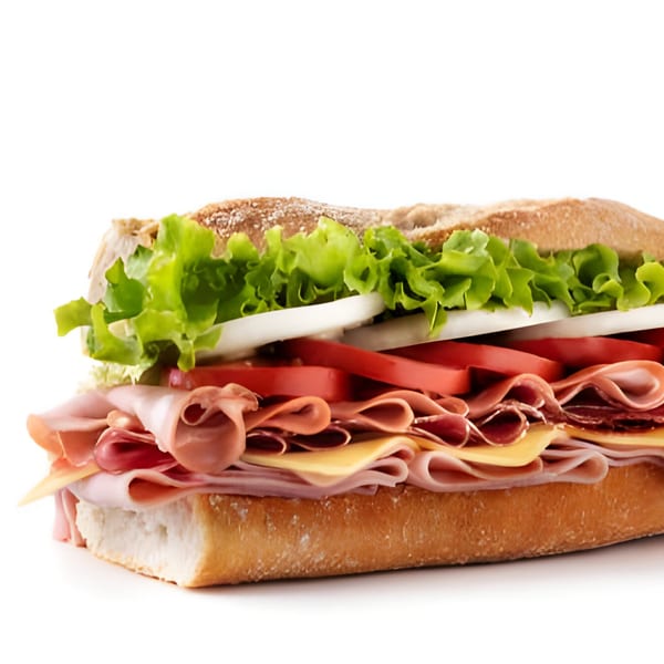 A large Zee's Kitchen American sub sandwich with ham, cheese, tomatoes, onions, and lettuce.
